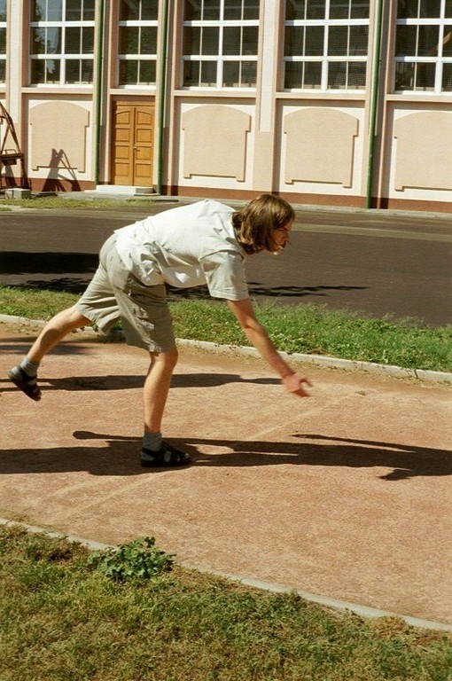 a contestant posing....err, no, he is just playing pétanque