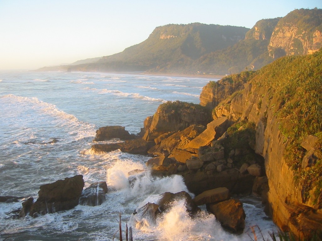 further to the left, as a medium wave splashes onto the rocks